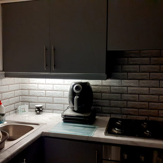 Under cabinet lighting glowing over a kitchen worktop in an Irish home