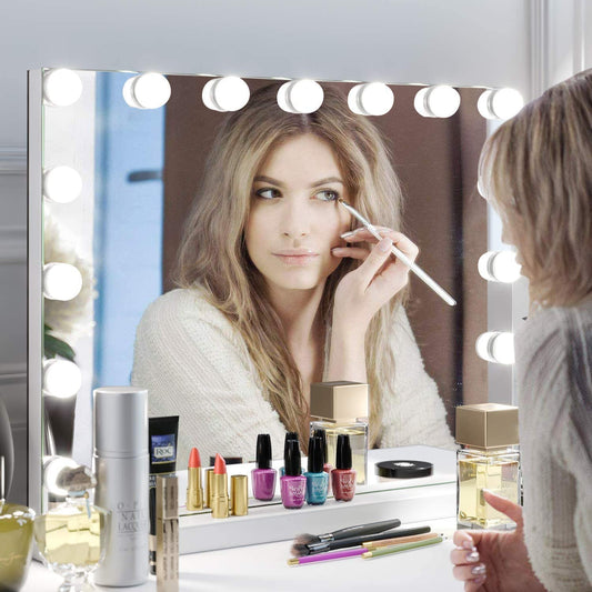 Woman applying make up at a lit Hollywood LED vanity mirror in an Irish bedroom