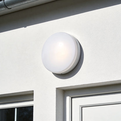 Round white LED bulkhead light mounted on exterior wall