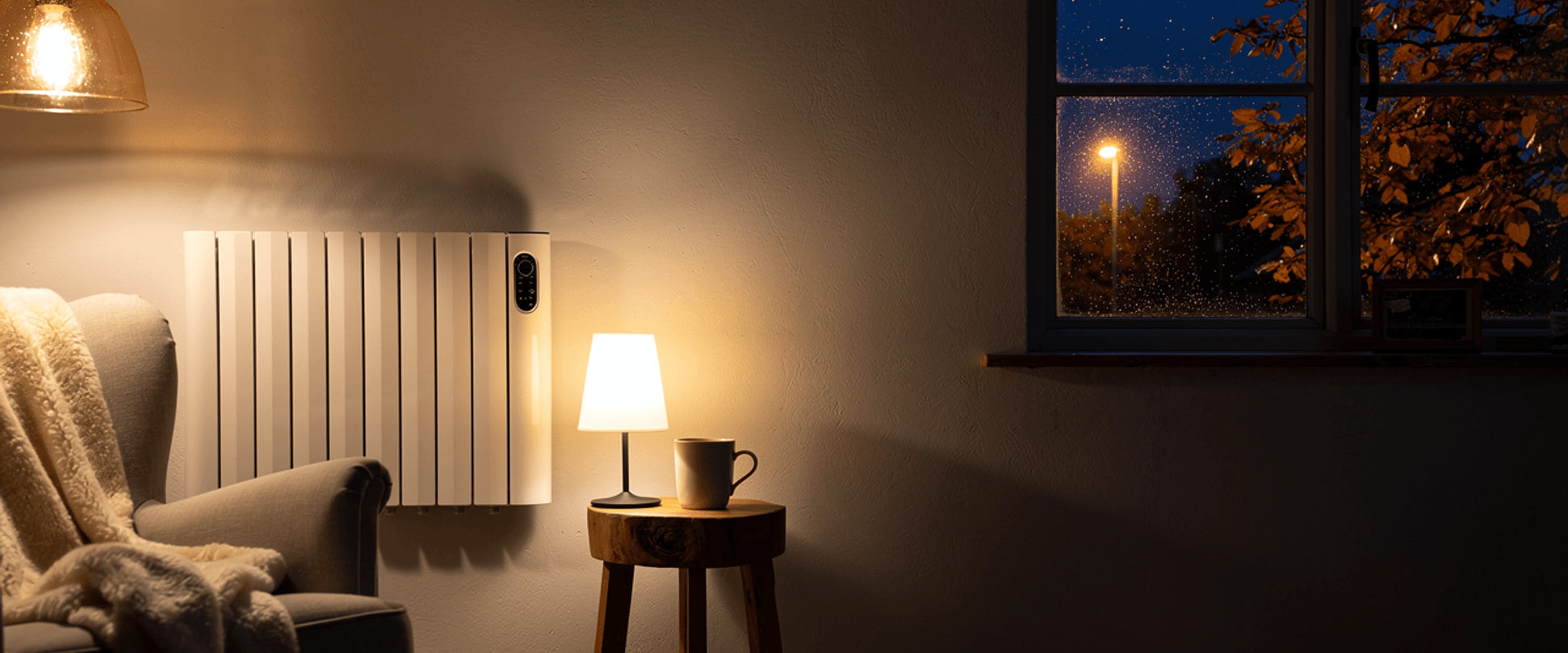 Wall mounted smart electric radiator warming a cosy Irish living room at dusk, with rain and autumn leaves on the window
