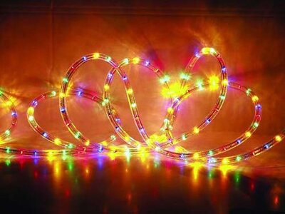 Evolec multicolour LED rope light lit in red, yellow, blue and green, coiled on a dark background