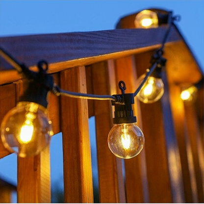 10m clear warm white LED festoon lights glowing on a wooden railing at dusk
