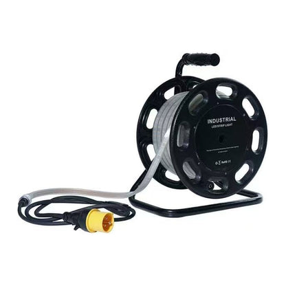 Greenlamp 50 metre 110V LED site lighting reel with the IP65 strip wound on a black steel carry reel and a yellow 16A 110V plug fitted