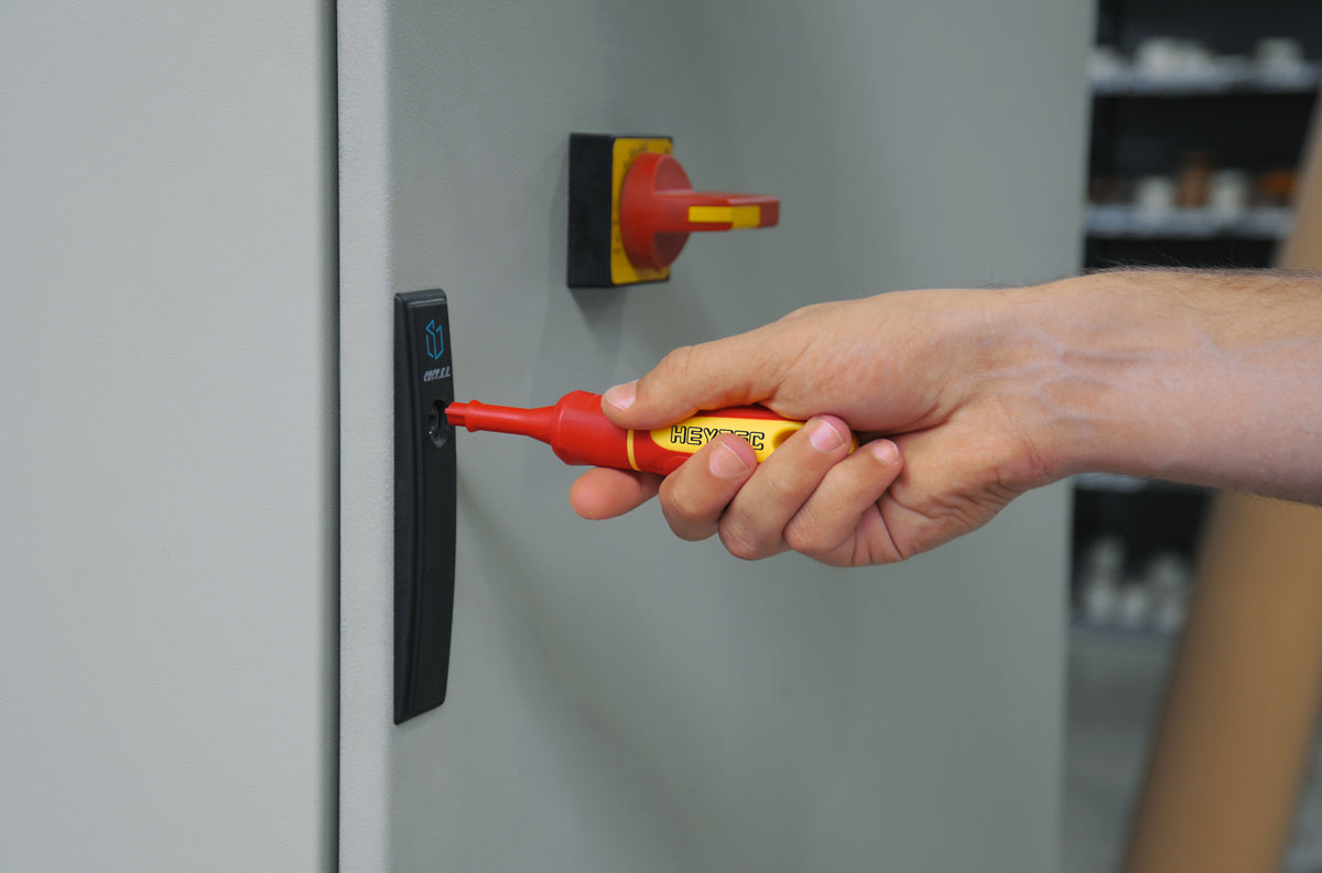 Heytec VDE insulated control-cabinet key opening an electrical panel; 1000V interchangeable system.