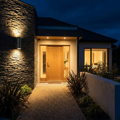 Black GU10 up and down wall light beside a contemporary house front door at night