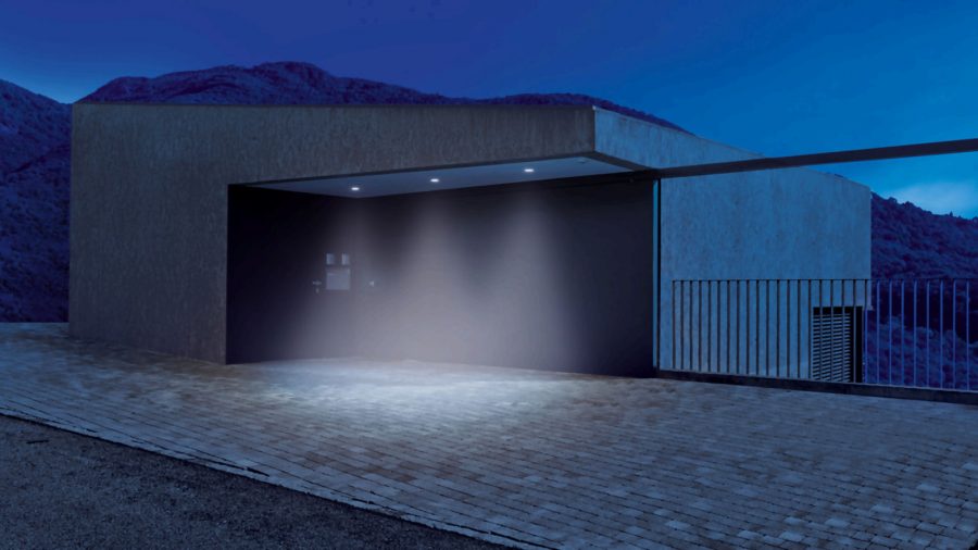 Steinel IS 2360 ECO 360° surface PIR installed on a ceiling, activating exterior lights at night.