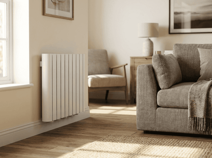 A white Titan smart WiFi electric radiator wall mounted low beneath a window in a bright Irish living room, with no pipework or valves