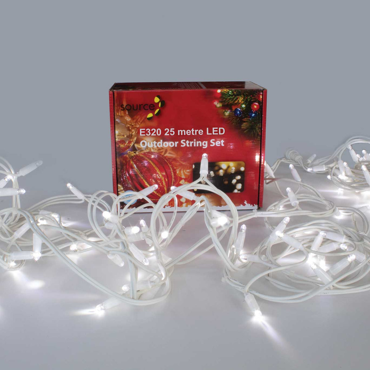 Source white cable LED string lights lit in clear white, piled in front of the Source outdoor string set box